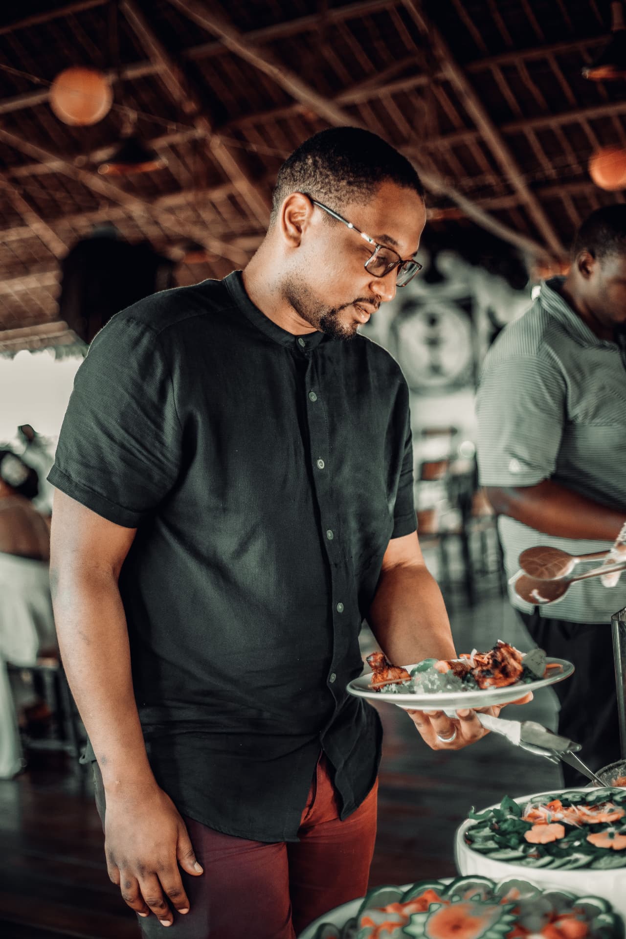 A dad serving himself food at a buffet